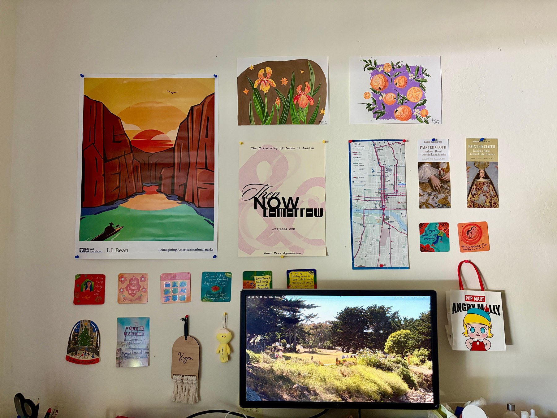 Keyan's colorful art and inspiration wall above her desktop