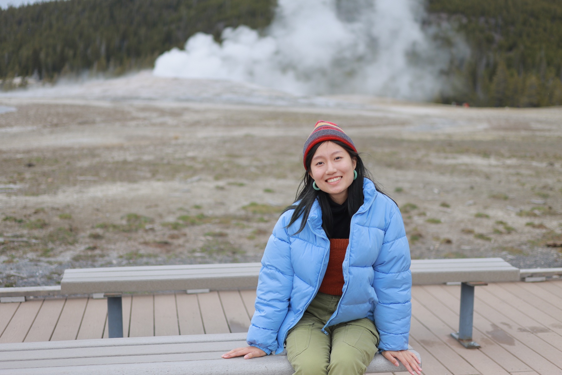 Keyan visiting Yellowstone in a blue jacket