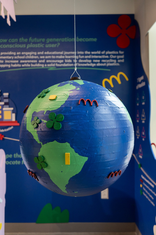 Interactive globe suspended in the Plastic Universe exhibition with colored markers